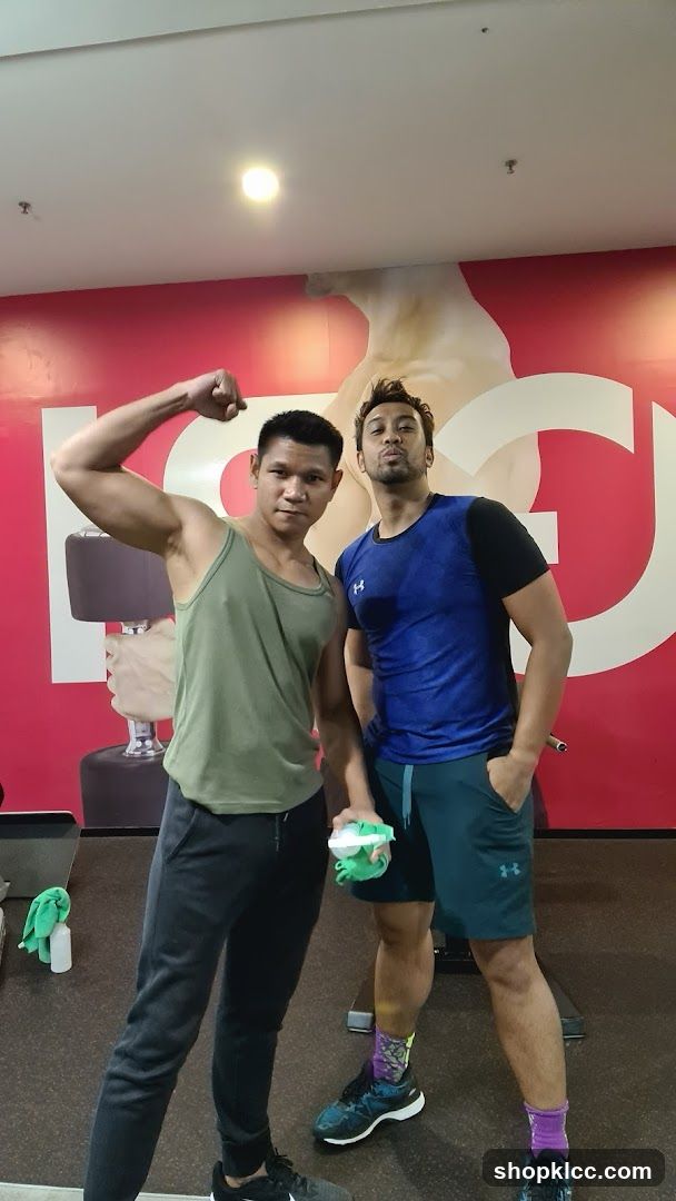 Two men posing in a gym