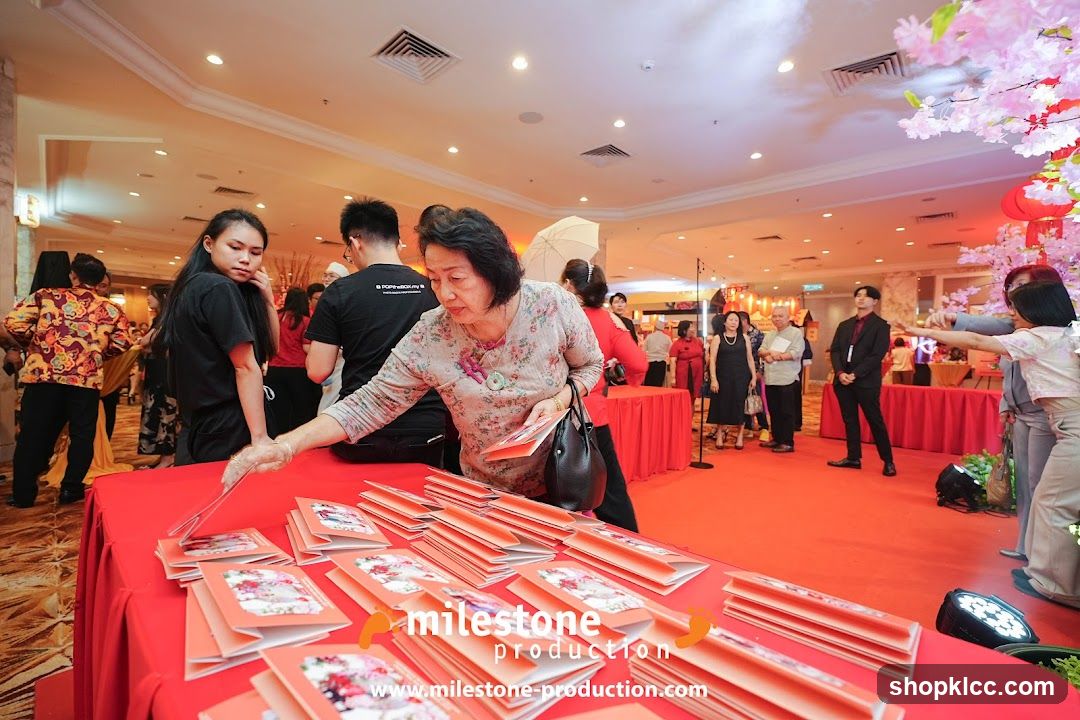 People at an event with red tables and decorations