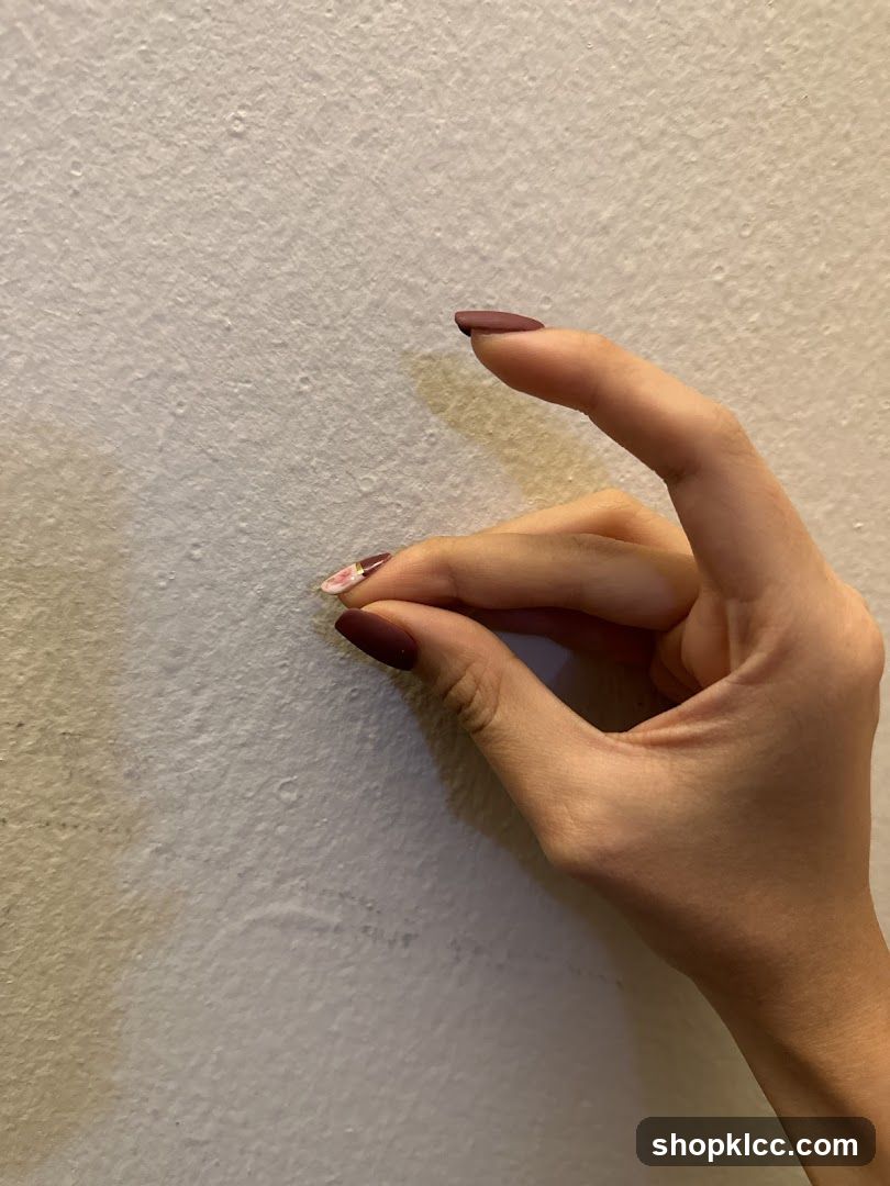 Fingers Pinching Wall
