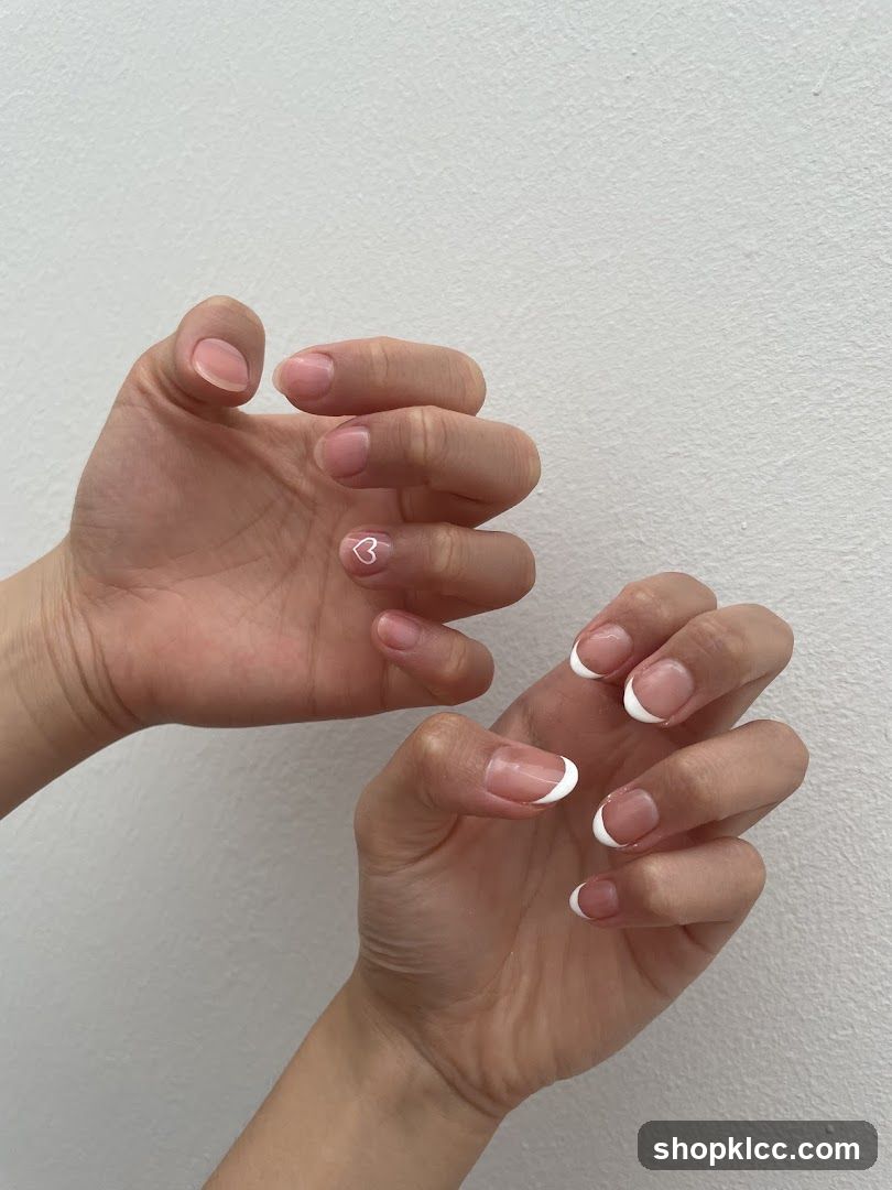 Nails with French tips and a heart design