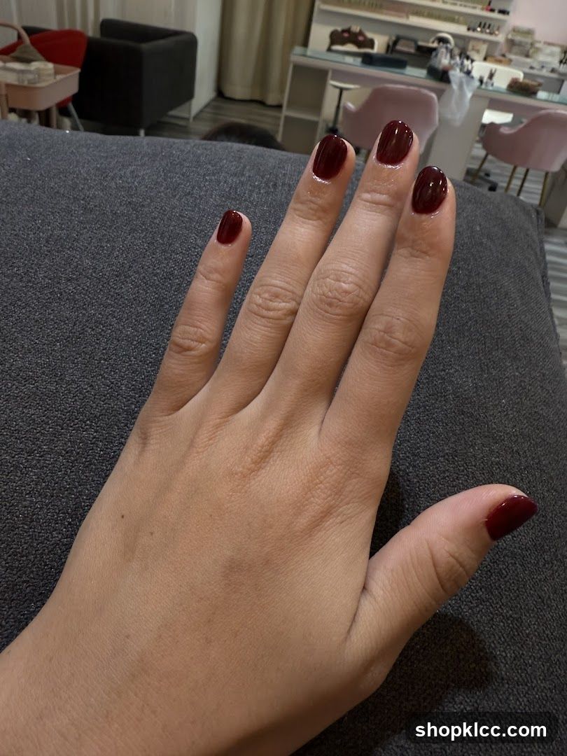 Hand with dark red nails