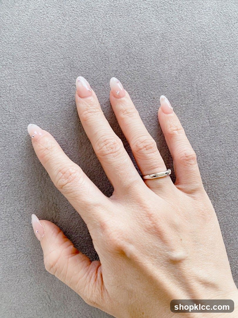 Hand with French tip nails and ring