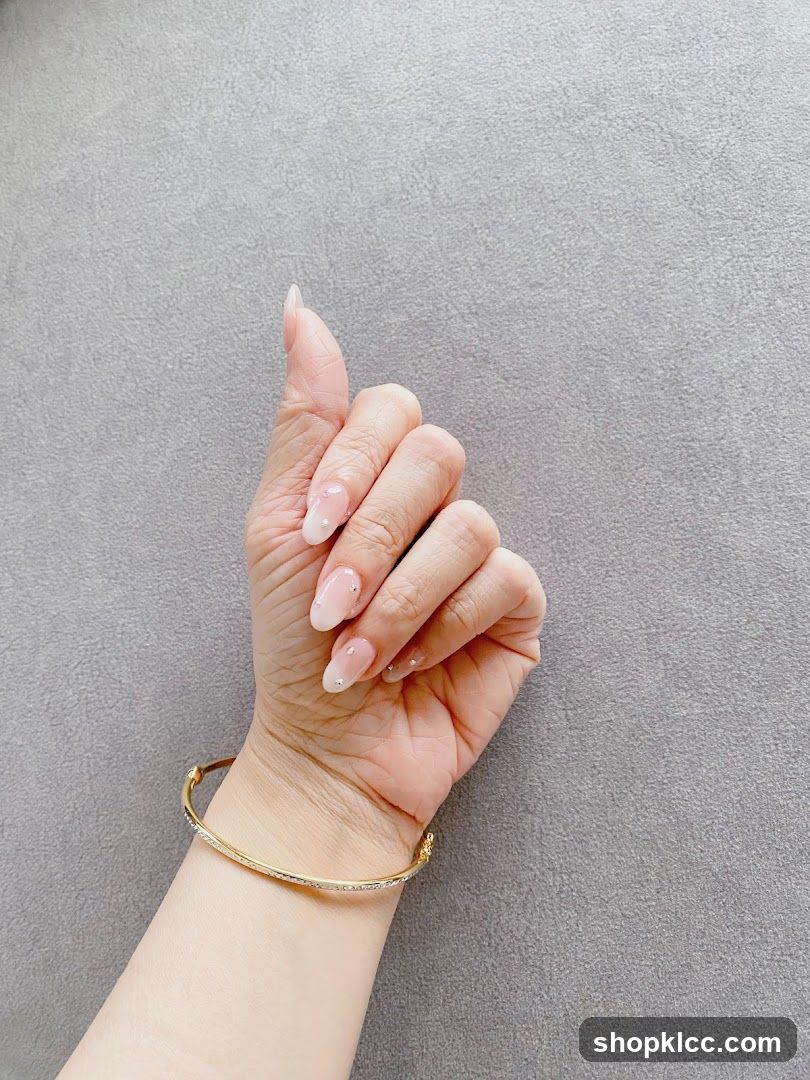 Woman's Hand with French Manicure and Bracelet