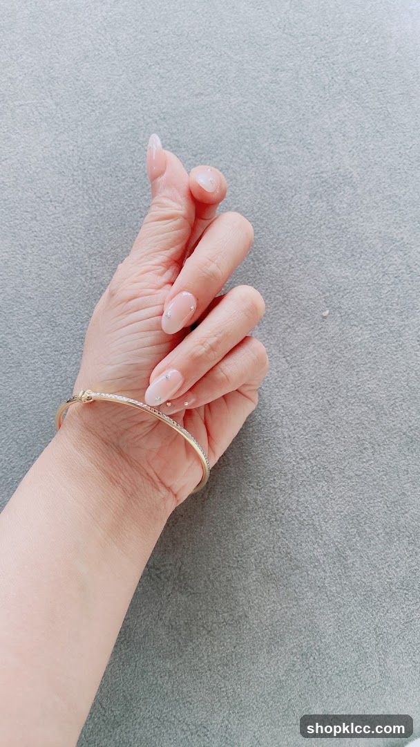 Hand with bracelet and decorated nails