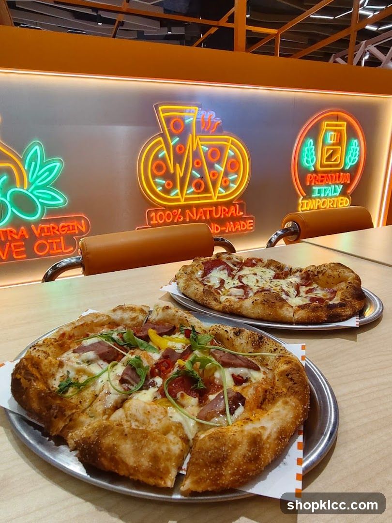 Pizzas on a table with neon signs