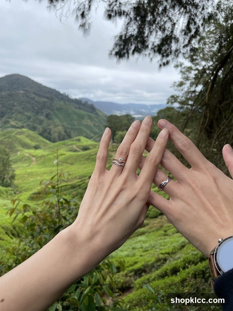 Hands with rings against tea plantation view
