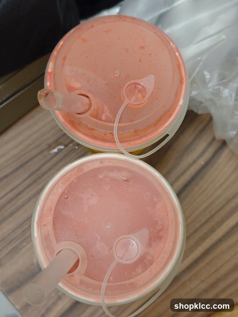 Two pink drinks with straws