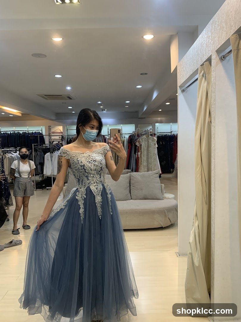 Woman trying on a blue gown