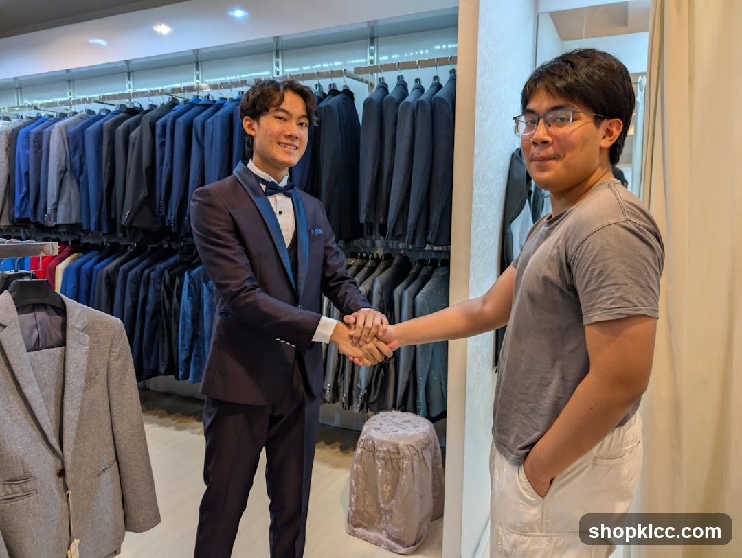 Two young men shaking hands in a suit shop