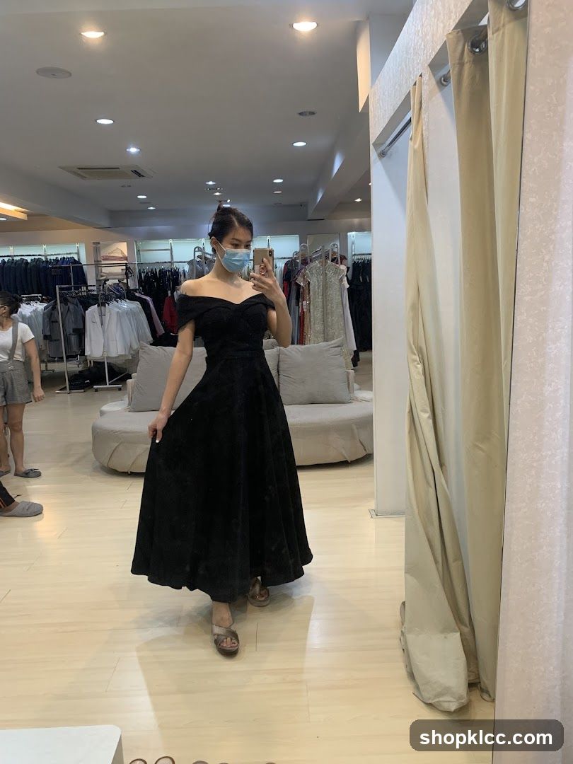 Woman trying on a black dress