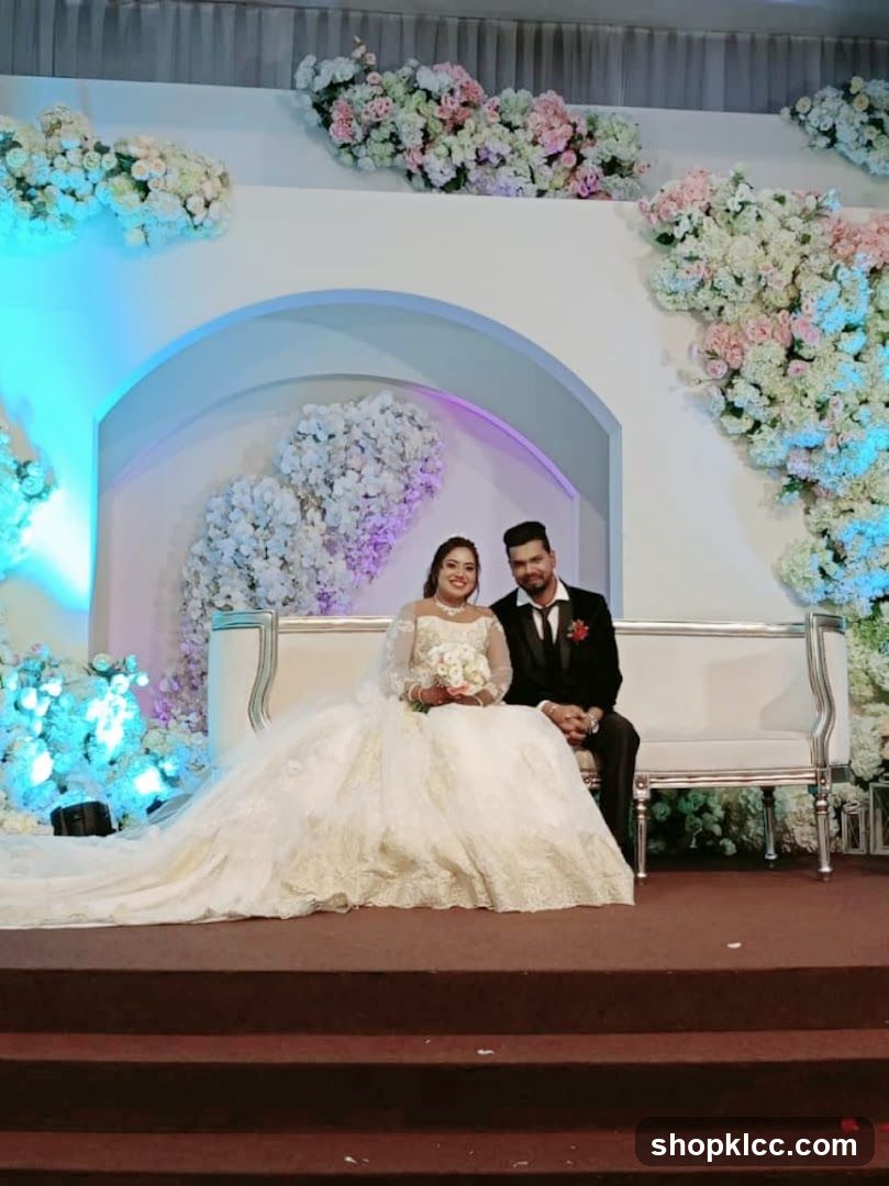 Wedding Couple Posed on a White Sofa