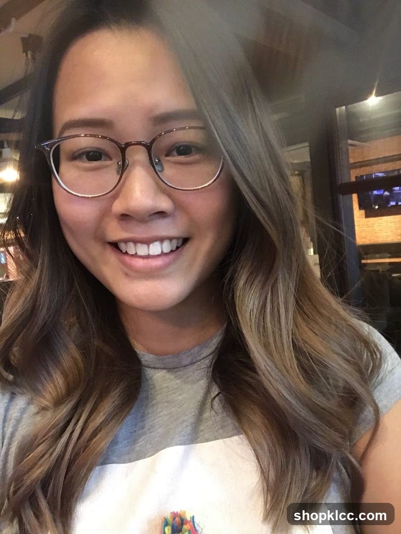 Selfie of a woman with glasses and wavy hair