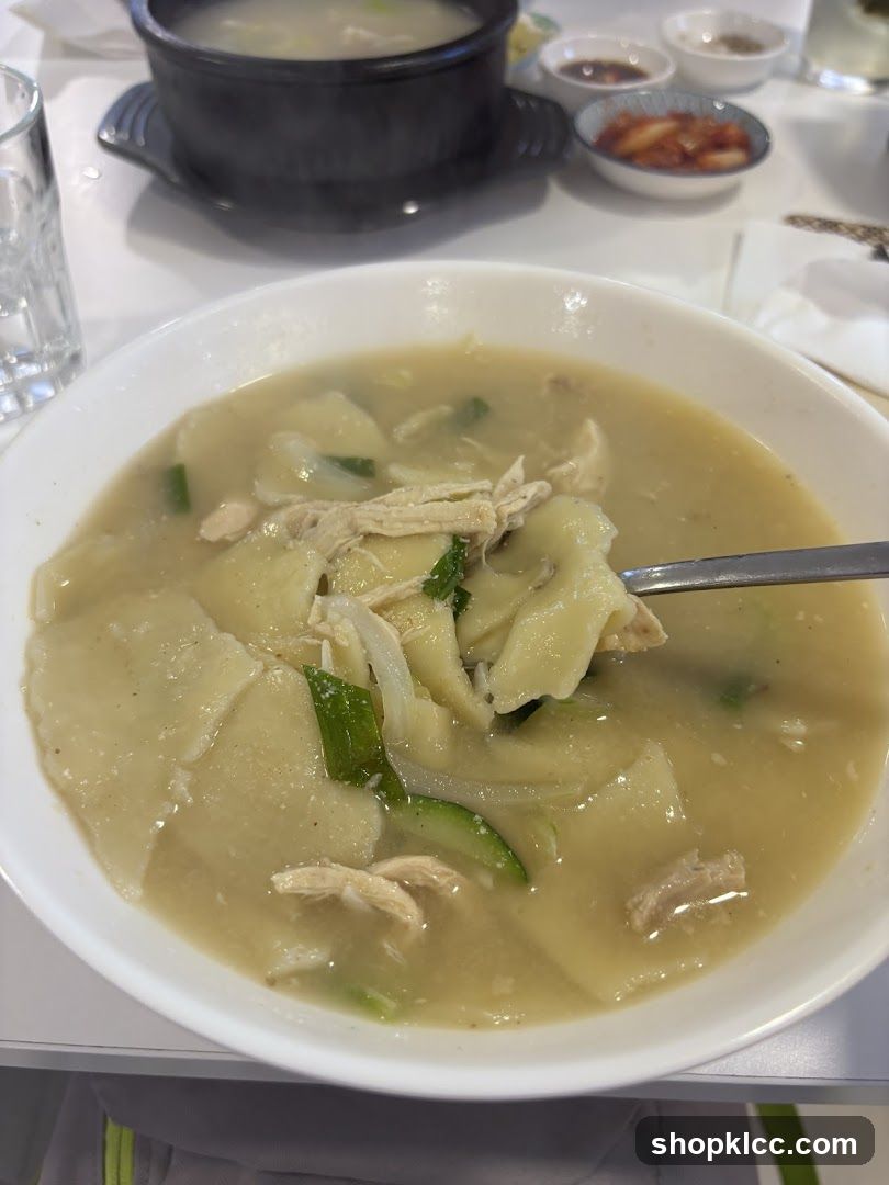 Bowl of Chicken Soup with Potatoes and Greens