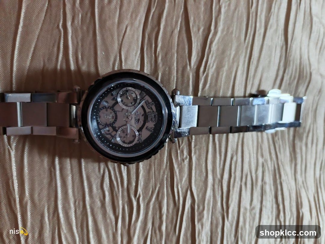 Metal Watch on Fabric Background