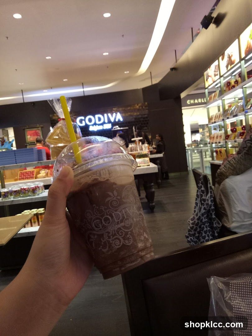 Person holding a Godiva chocolate drink