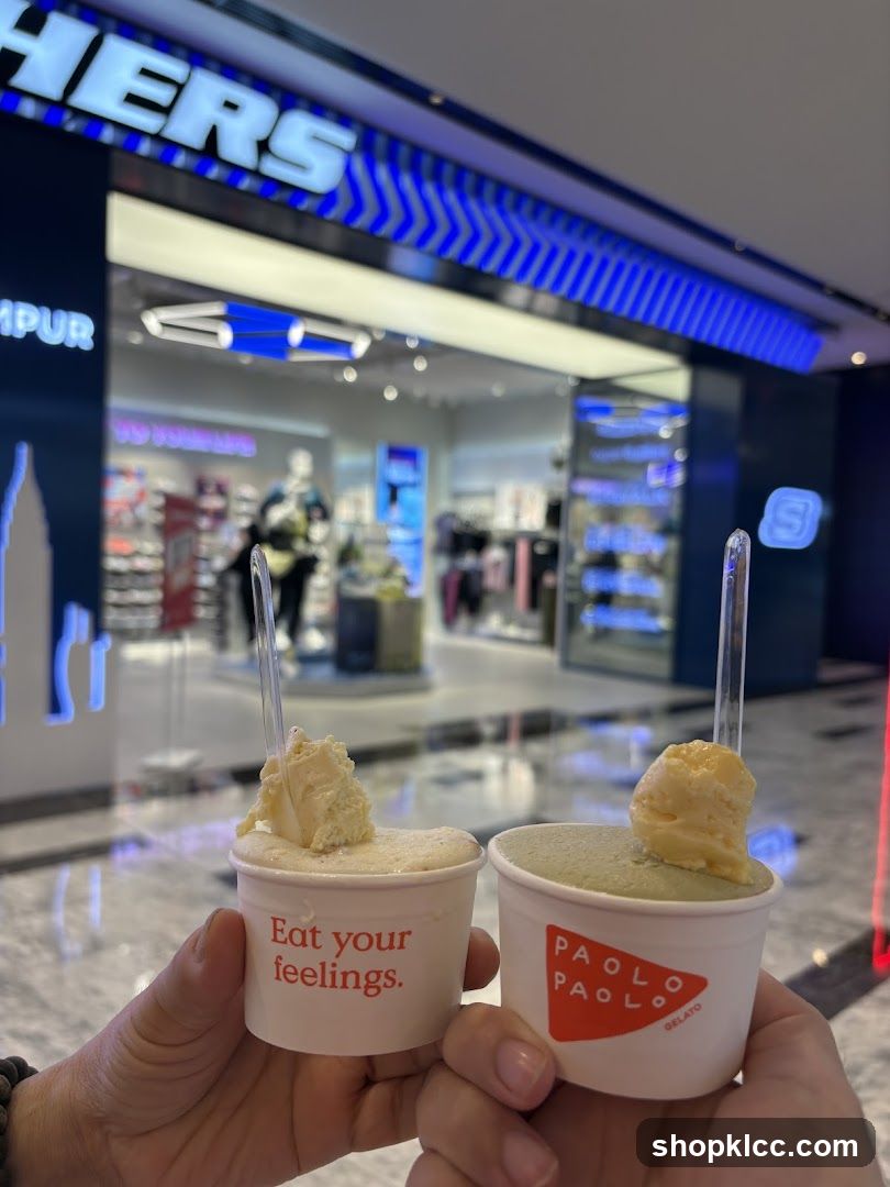Two cups of gelato in front of a Skechers store