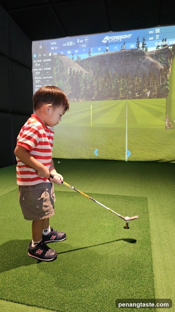 Young boy playing indoor golf