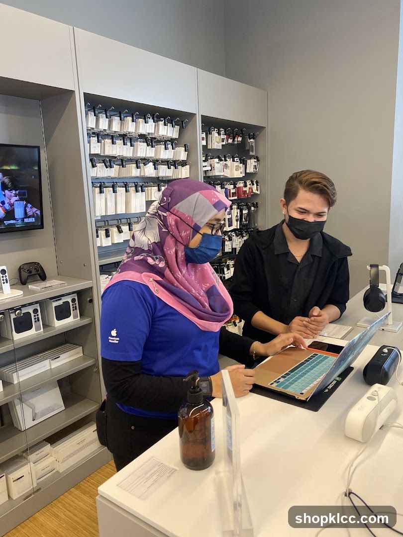 Apple Store Employees Assisting Customer