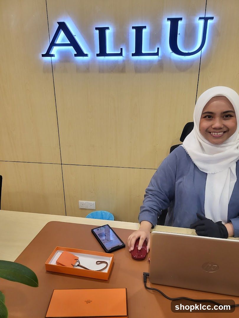 Woman at Desk with Laptop and Hermes Item