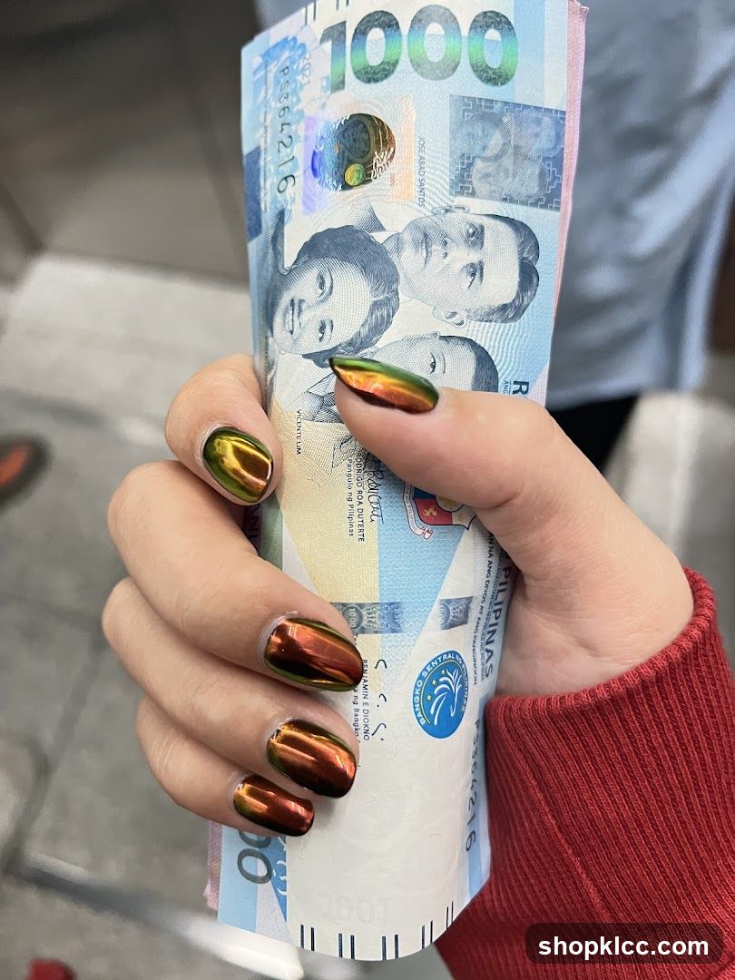 Hand holding Philippine currency