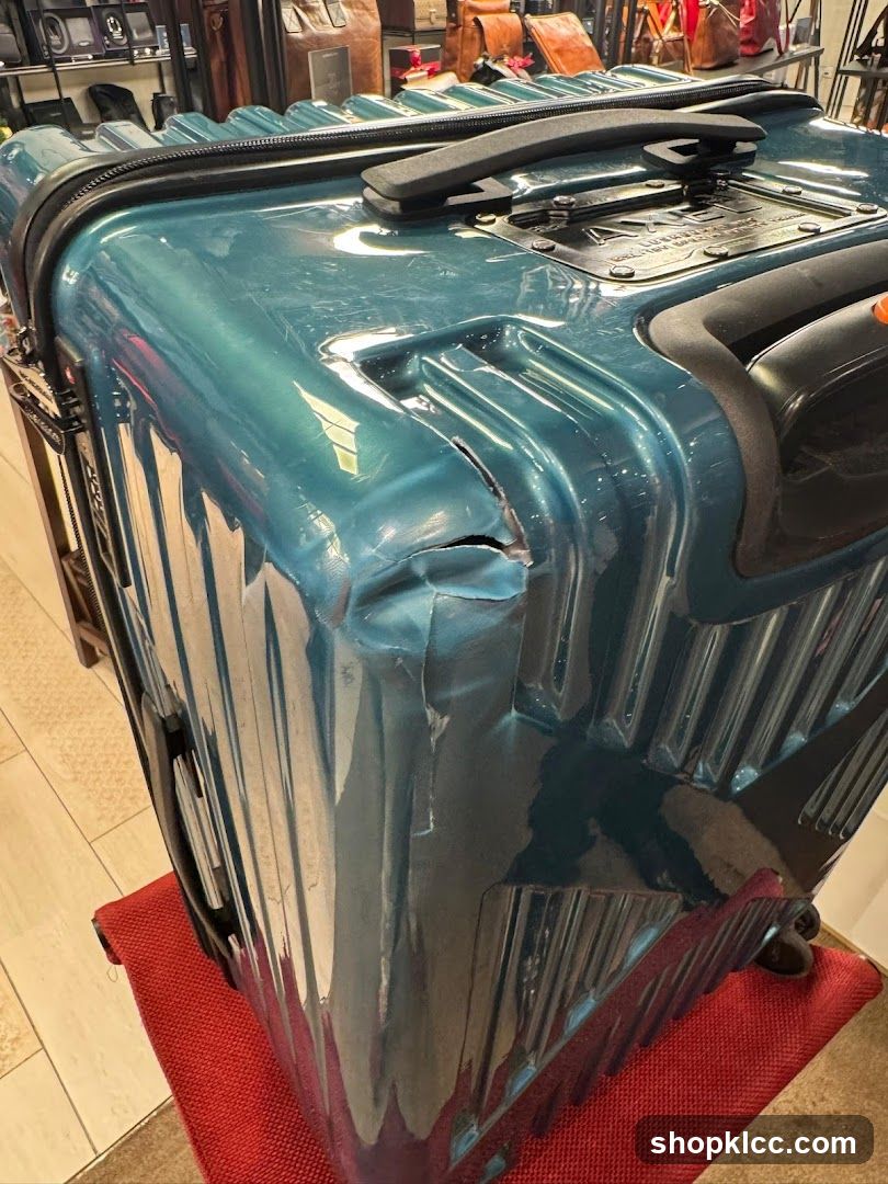Damaged Teal Suitcase