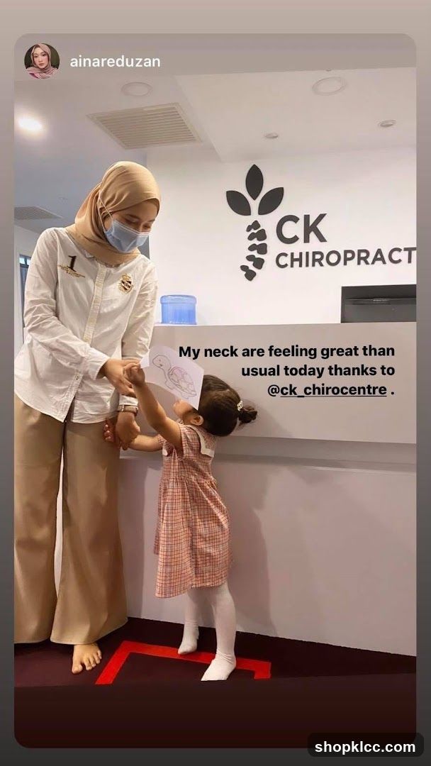 Chiropractor with child at reception desk