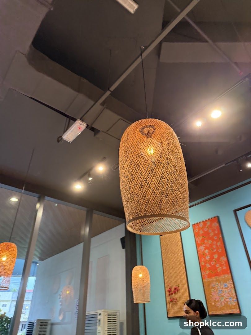 Interior of a restaurant with woven lamps and artwork