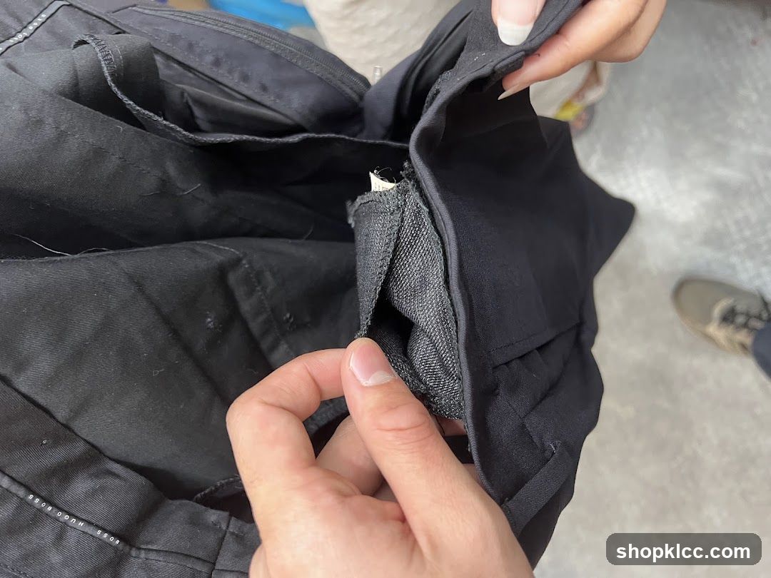 Close-up of black pants with visible label