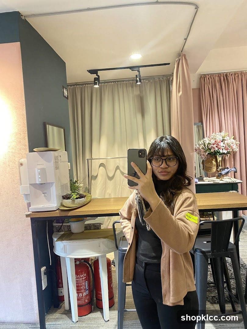 Woman taking a mirror selfie in a store