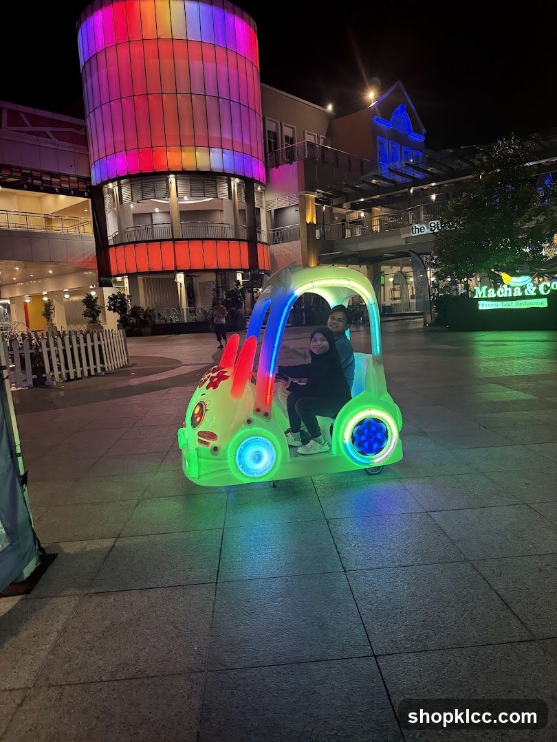 Night scene with illuminated vehicle and building
