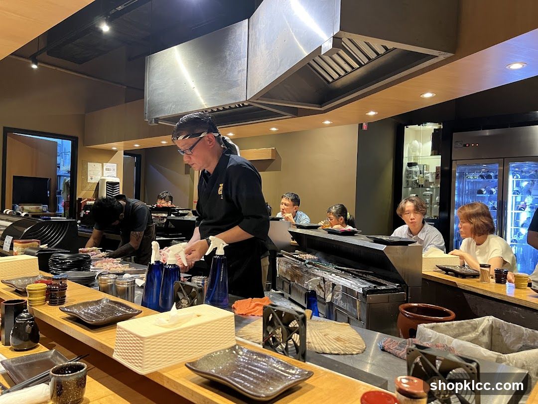 Chefs preparing food at a sushi bar