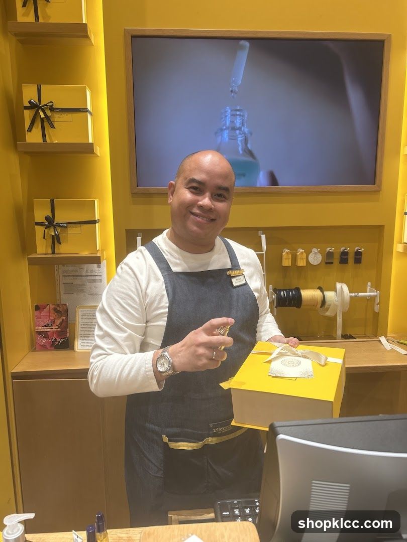 Sales associate spraying a gift box