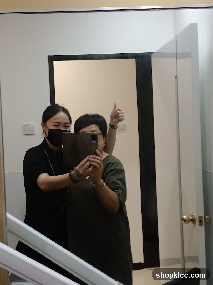 Two people taking a mirror selfie