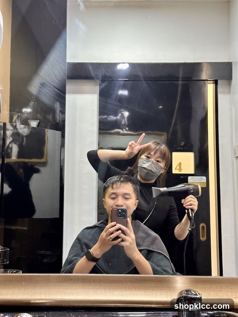 Hairdresser drying client's hair