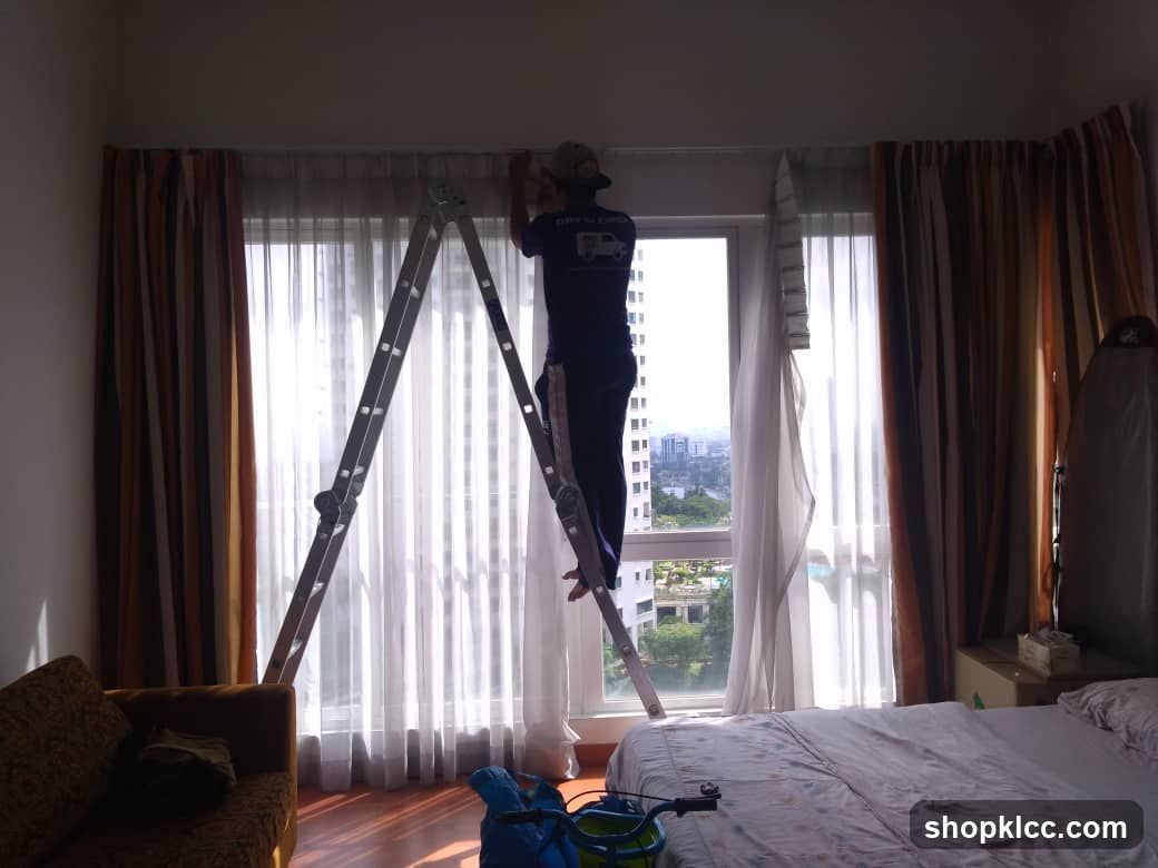 Man installing curtains