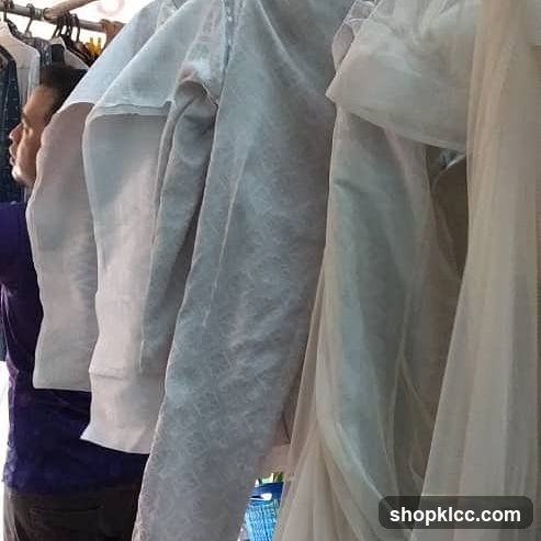Man looking at clothes on a rack