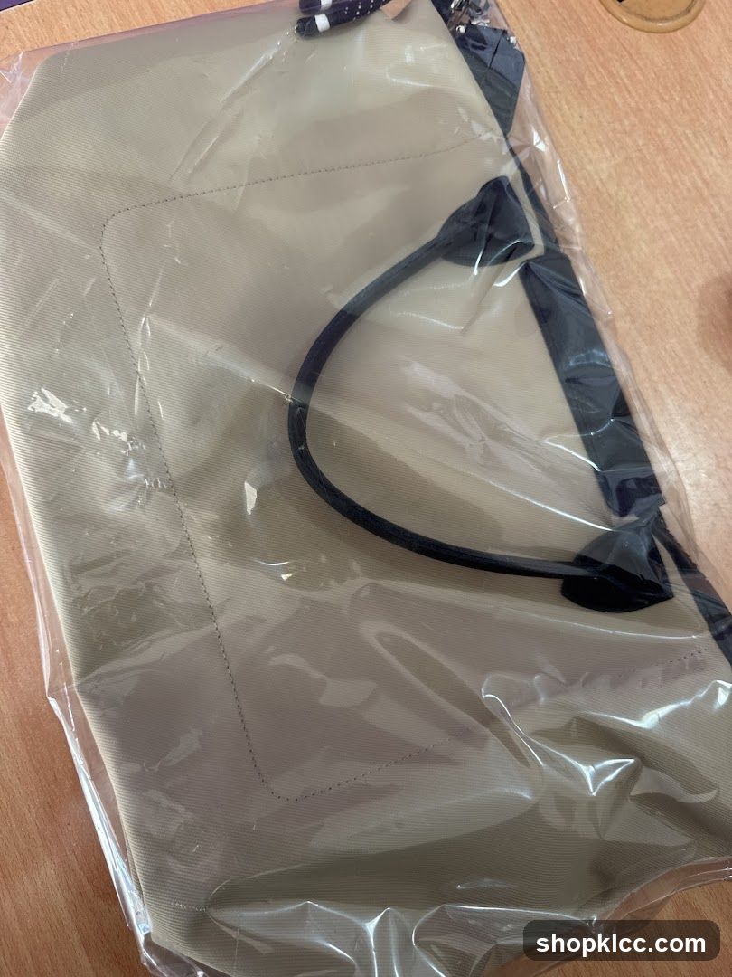 Beige tote bag in plastic packaging