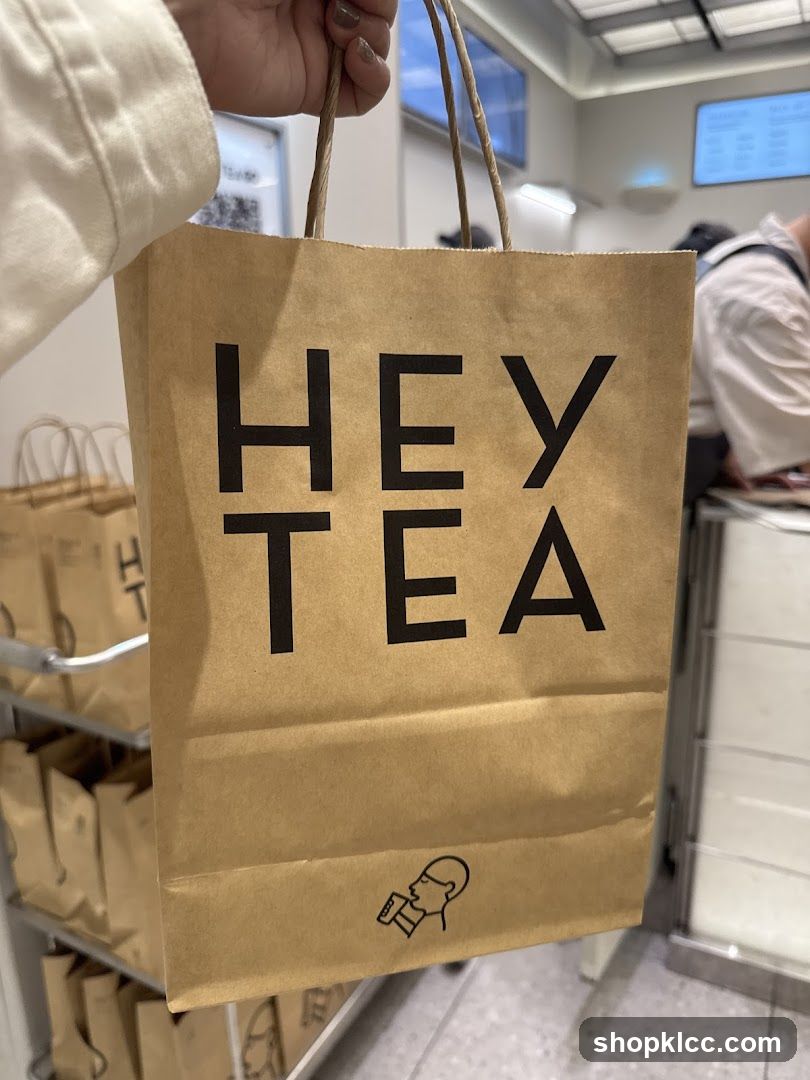 Brown paper bag with "HEY TEA" logo