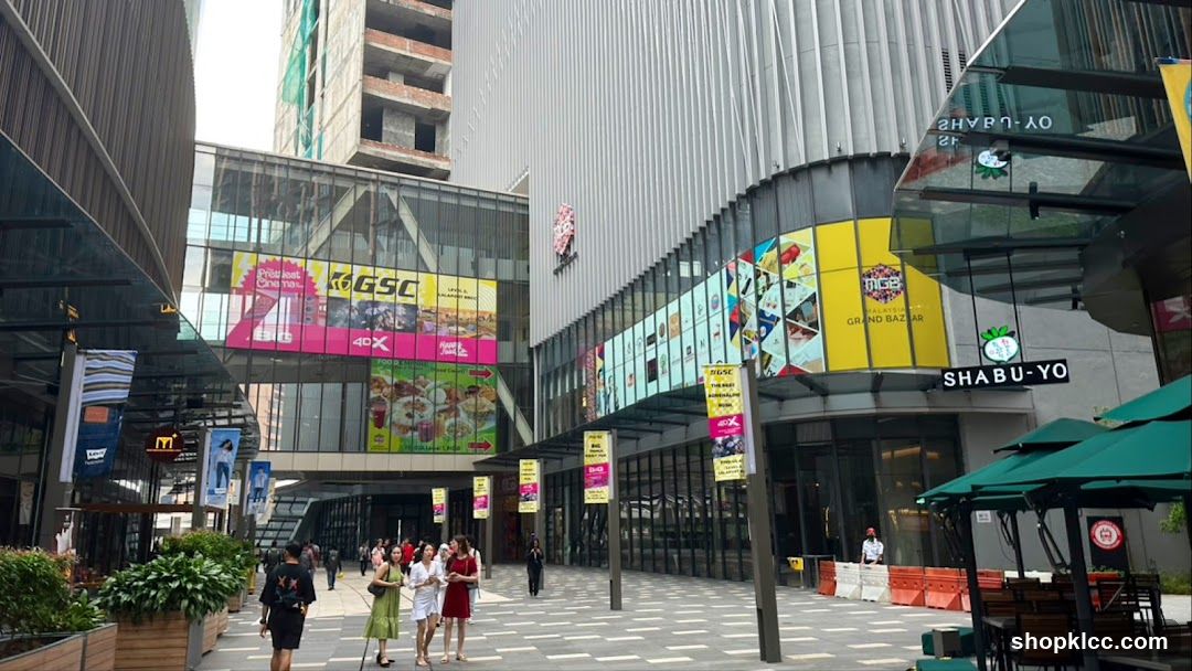 Outdoor shopping mall with various shops and advertisements
