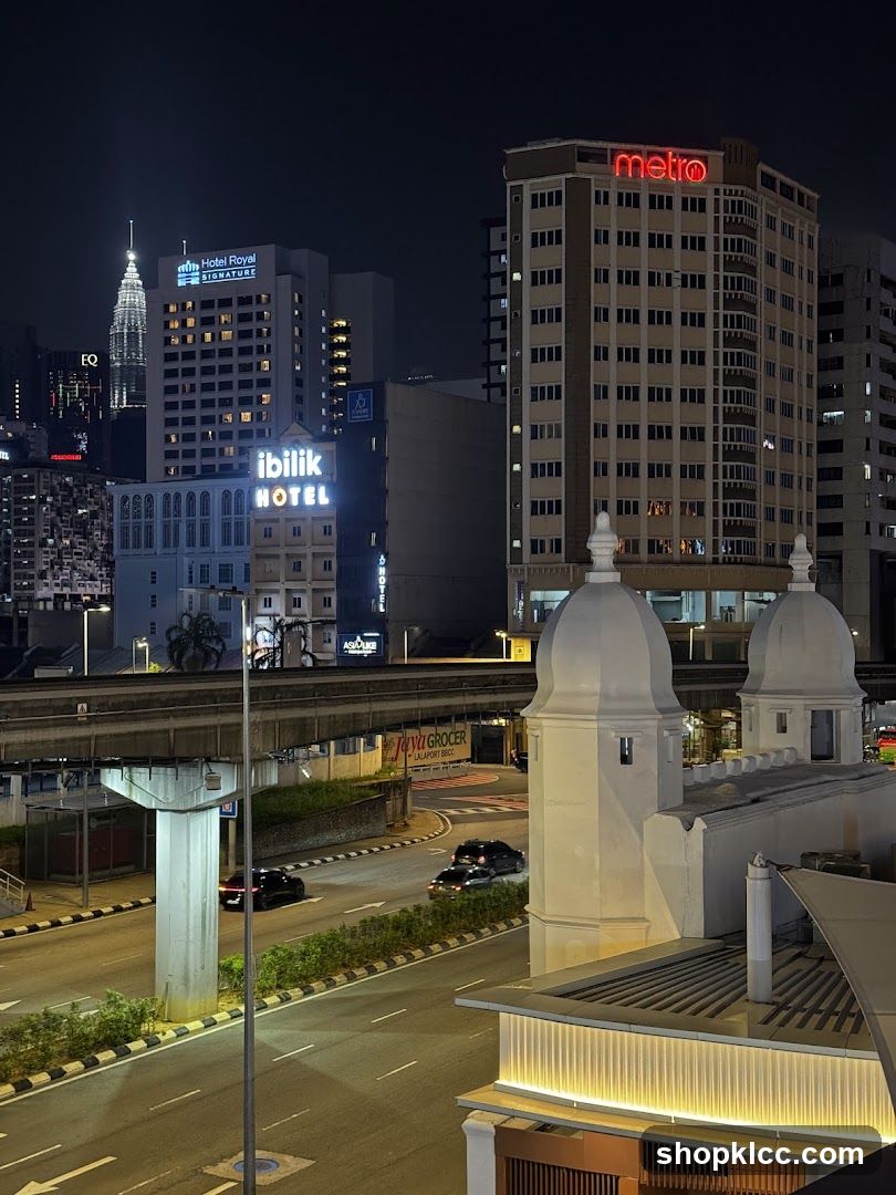 Cityscape at Night with Buildings and Elevated Train Track
