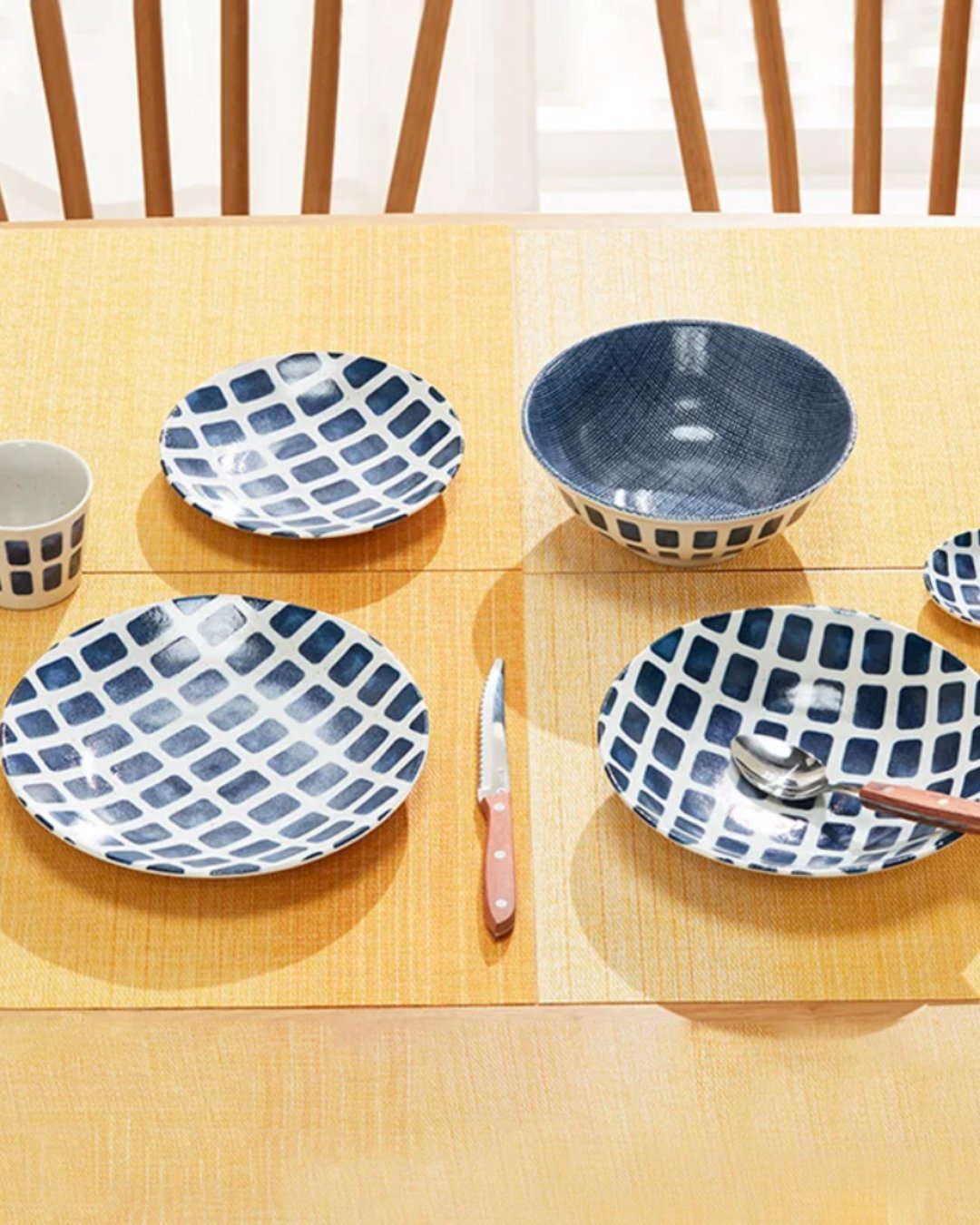 Blue grid tableware, bowls and a wooden-handled knife on a NITORI table setting